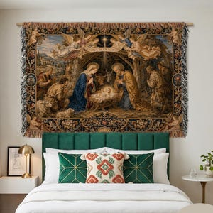 May include: A woven wall tapestry featuring a nativity scene with the Holy Family, angels, and shepherds, framed by a dark floral border with fringe edges. The text Gloria in Excelsis Deo is visible above the manger. The tapestry measures 203 cm by 152 cm.