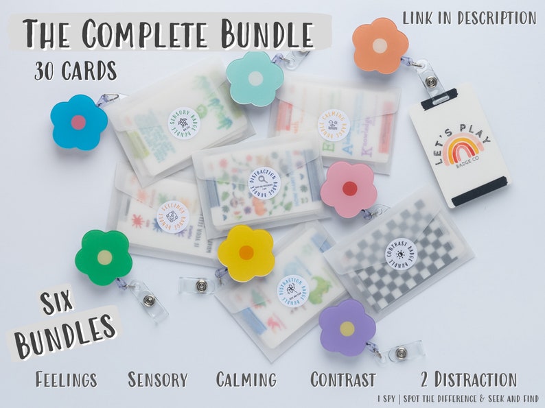 May include: A set of six colourful flower-shaped lanyards with clear plastic pouches containing 30 cards. The pouches are labelled with the words "Feelings", "Sensory", "Calming", "Contrast", and "2 Distraction". The text "Let's Play" is visible on a black card with a rainbow design.