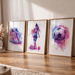 May include: Three framed watercolour art prints. The prints depict a pair of football boots, a football player in a jersey with the number 10, and a football. The artwork uses a vibrant palette of purple, pink, and blue.