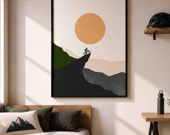 Peut inclure: Une impression d'art mural encadrée représentant la silhouette d'une personne sur un VTT au bord d'une falaise. La scène comprend un grand soleil orange sur un fond pâle, avec des chaînes de montagnes superposées dans des tons vert foncé et gris.