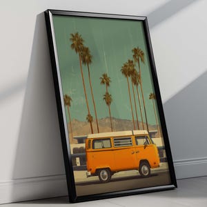 May include: Framed art print featuring an orange vintage van parked on a road, with tall palm trees and mountains in the background. The sky is a muted teal color. The artwork is in a black frame.