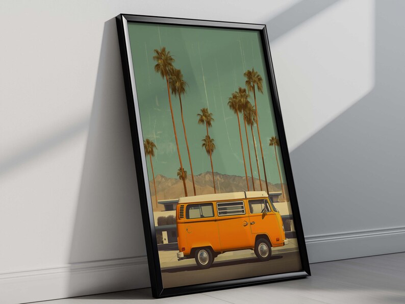 May include: Framed art print featuring an orange vintage van parked on a road, with tall palm trees and mountains in the background. The sky is a muted teal color. The artwork is in a black frame.