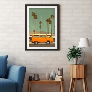 May include: Framed art print featuring an orange vintage van driving past palm trees under a teal sky. The artwork has a retro aesthetic, with a black frame and a white brick wall background. The scene evokes a sense of travel and nostalgia.