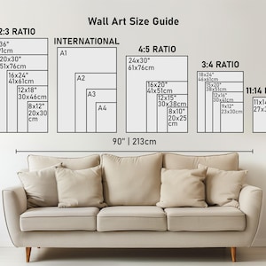 May include: A Wall Art Size Guide chart displaying various frame dimensions in inches and centimeters, categorized by ratios including 2:3, 4:5, 3:4, 11:14, and International A1-A4 sizes, positioned above a beige sofa measuring 90 inches wide.