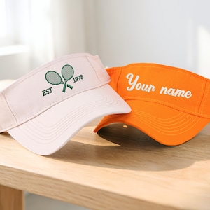 May include: A set of three ceramic mugs with a speckled, matte finish. Each mug features a different color: light blue, cream, and gray. The mugs have a simple, modern design and a comfortable handle.