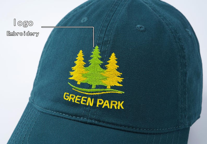 May include: A dark green baseball cap with an embroidered logo of three green trees with yellow accents. The logo reads "GREEN PARK".
