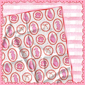 May include: A white fabric with a repeating pattern of pink seashells, seahorses, and bows within red oval frames. The fabric has a textured appearance and is surrounded by a pink scalloped border. The word "didaldo" is visible in the border.