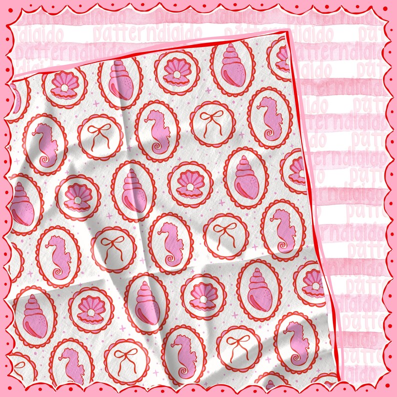 May include: A white fabric with a repeating pattern of pink seashells, seahorses, and bows within red oval frames. The fabric has a textured appearance and is surrounded by a pink scalloped border. The word "didaldo" is visible in the border.
