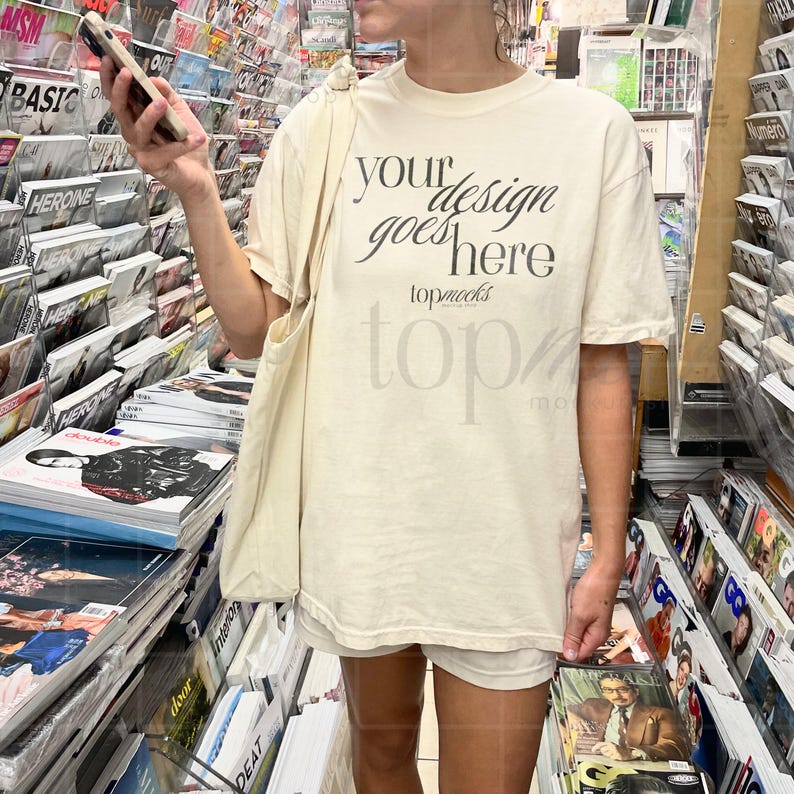 This Comfort Colors C1717 Ivory Shirt Mockup is perfect for showcasing your designs featuring an oversized fit this mockup is ideal for creating aesthetic mockups for women including Y2K selfie city styles in a real-world setting
