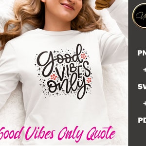 May include: A white long-sleeved shirt with a black graphic that says "Good Vibes Only" in a stylised font. The graphic also includes small red flowers and black stars.