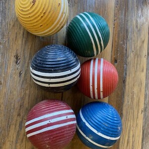 A set of 6  vintage chippy croquet balls, bowl fillers