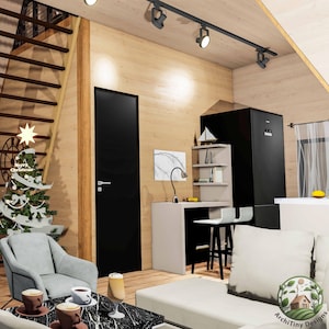 May include: A modern living room with a black door, a white couch, a small Christmas tree, and a black refrigerator. The room has a wood floor and a white ceiling with track lighting.