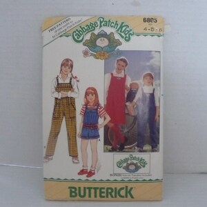 May include: A Butterick sewing pattern envelope for Cabbage Patch Kids clothing, model 6805, sizes 4-5-6. The cover features illustrations of children wearing overalls, a jumper, and shorts, with the Cabbage Patch Kids logo and text printed on the front.