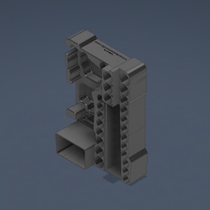 Può includere: Un supporto organizzatore grigio scuro stampato in 3D con molteplici fori cilindrici per riporre utensili, uno scomparto rettangolare e un profilo laterale sagomato. Il testo www.printables.com è visibile sulla superficie superiore.