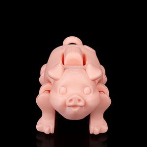 May include: A light pink, 3D-printed pig-shaped object. The pig has a rounded body, four legs, a small tail, and a loop on its back. The pig's face features small eyes, a snout, and a smiling mouth. The object is set against a black background.