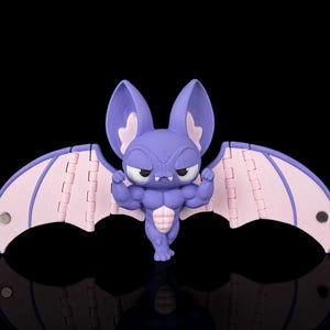 May include: A purple and light pink articulated bat figurine with a muscular physique, large pointed ears, and small fangs. The bat has wide, segmented wings with visible hinges and small circular magnets embedded at the tips of each wing.