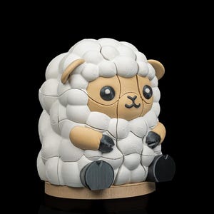 May include: A 3D-printed sheep figurine with a white, textured wool-like body. The sheep has tan-colored face, ears, and arms, with black hooves. It sits on a light brown circular base against a black background.