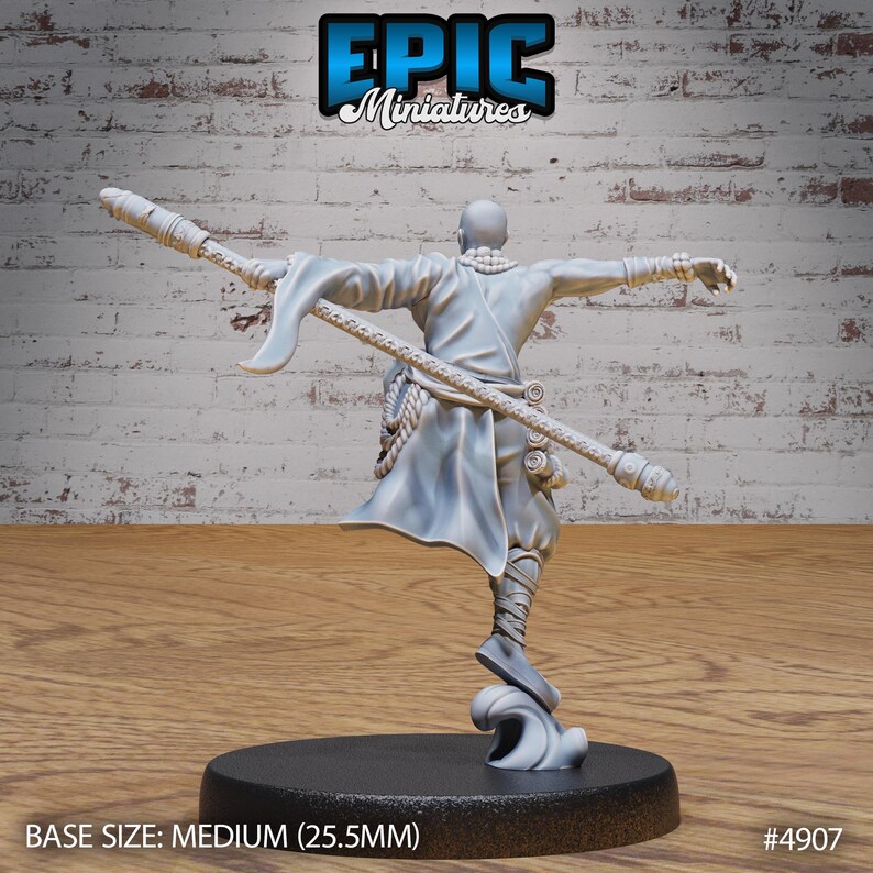 May include: A grey unpainted miniature of a person in a robe holding a staff. The miniature is standing on a round base with a wave design. The base is 25.5 mm in diameter. The miniature is part of the Epic Miniatures line. The text "EPIC Miniatures" is visible at the top of the image.