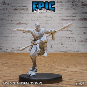 May include: A gray painted miniature figurine of a person in a flowing robe holding a staff. The figurine is posed in a martial arts stance. The base is a medium size, 25.5 mm. The figurine is labeled "#4907".