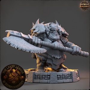 May include: A detailed miniature figure of a fantasy creature, holding a large axe. The figure is gray and has a menacing expression. The base is decorated with skulls. The Daybreak Miniatures and The Lardy League of Bronkenhausen logos are visible.