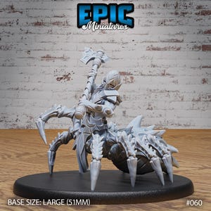 May include: A gray, detailed miniature of a humanoid figure riding a spider, holding a weapon. The miniature is on a black base. BASE SIZE: LARGE (51MM) #060