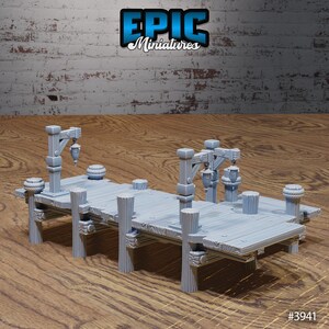 May include: A gray plastic model of a wooden dock with two lamp posts and lanterns. The dock has a wooden plank surface and is supported by wooden posts. The dock is designed for use in tabletop games and role-playing games. #3941