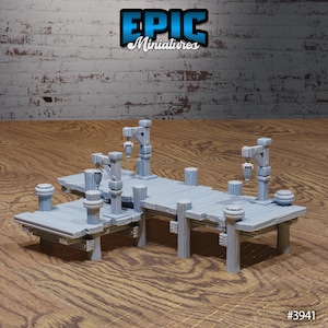 May include: A gray plastic model of a wooden dock with two cranes and rope details. The dock is made up of multiple sections that can be connected together. The model is designed for use in tabletop games and role-playing games. #3941
