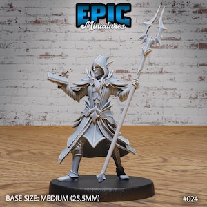 May include: A gray 3D printed miniature of a wizard holding a book and a staff. The wizard is wearing a robe with a star design. The miniature is on a black base. BASE SIZE: MEDIUM (25.5MM) #024