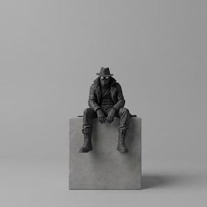 May include: A monochromatic black figurine of a character wearing a fedora, a long trench coat, gloves, and lace-up boots. The figure is seated on a light gray cube, featuring a mask with circular eye lenses and a double-breasted coat design.