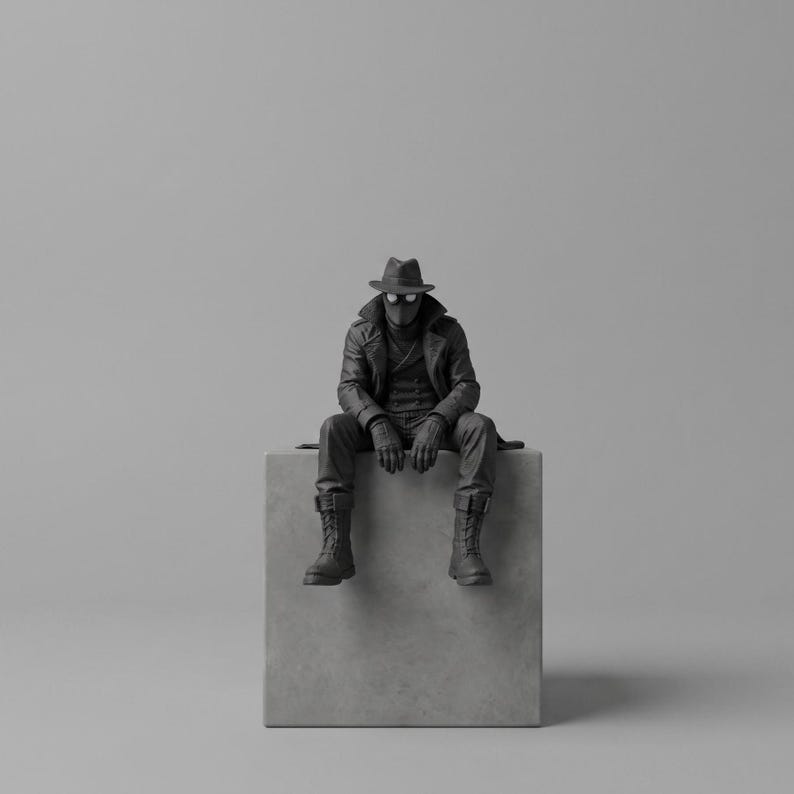 May include: A monochromatic black figurine of a character wearing a fedora, a long trench coat, gloves, and lace-up boots. The figure is seated on a light gray cube, featuring a mask with circular eye lenses and a double-breasted coat design.