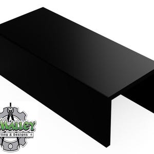 May include: A glossy black rectangular display stand with a U-shaped opening. The stand is made of a solid material and has a smooth, reflective surface. The logo "O'Malley Drafting & Designs" is in the lower left corner.