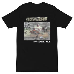 May include: Black t-shirt with the text "BUZZKILL" above a graphic of a house and car in a desolate landscape. The text "HOUSE OF BAD TOUCH" is printed below the graphic.