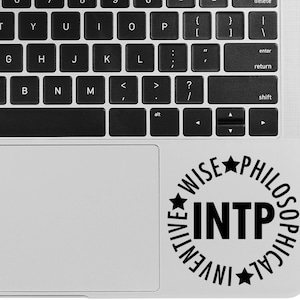 May include: A black and white sticker with the text "INTP" surrounded by the words "Wise", "Philosophical", "Inventive" and stars.