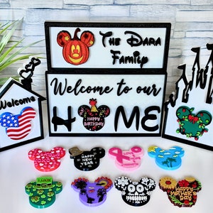 May include: A set of 10 Mickey Mouse-shaped wooden signs with various designs and text. The signs feature a variety of themes, including "Happy Birthday", "Happy New Year", "Love & Hope", "Lucky", "Happy Mother's Day", and more. The signs are perfect for decorating a home or adding a touch of Disney magic to any space.