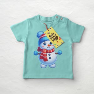 May include: A light blue baby t-shirt with a snowman graphic and a yellow tag that says "Baby T-shirt Mock Up".