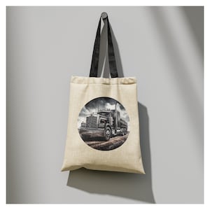 May include: A beige tote bag with black straps features a circular graphic of a black semi-truck driving on a dirt road.