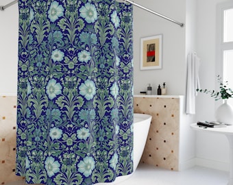 May include: A blue shower curtain with a floral pattern. The design features large, light blue flowers and green leaves against a dark blue background. The curtain is hanging in a bathroom setting.