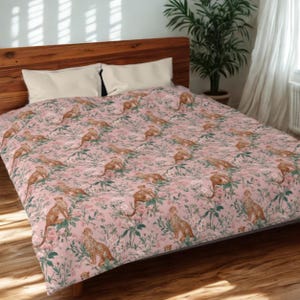 May include: A pink comforter with a repeating pattern of cheetahs and floral elements. The cheetahs are in a resting pose, and the flowers are in shades of pink and green. The comforter is on a wooden bed frame.