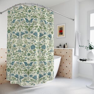 May include: A shower curtain with a floral pattern in shades of blue and green on a cream background. The pattern features butterflies, leaves, and flowers.