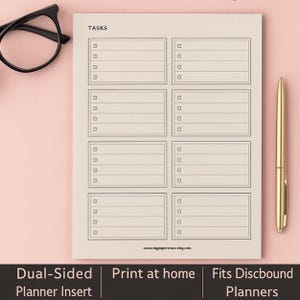May include: A beige planner insert with the word "TASKS" at the top. The insert features multiple rectangular sections with checkboxes and lines for writing. A gold pen and black glasses are on the side. The text "Dual-Sided Planner Insert" is at the bottom.