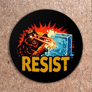 May include: Black round coaster with a cartoon cat wearing a crown, shooting laser beams from its eyes at a blue ice cube. The word "RESIST" is in yellow block letters below the cat.
