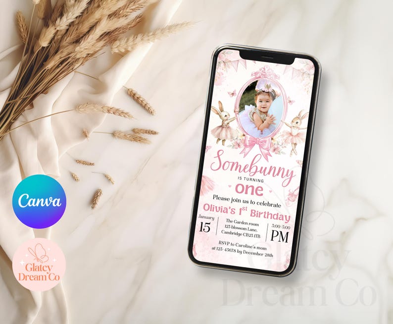 May include: A pink and white digital invitation with a photo of a baby girl in a pink tutu and bunny ears. The text reads "Somebunny is turning one. Please join us to celebrate Olivia's 1st Birthday. January 15, 5:00 PM. The Garden Room, 225 Blossom Lane, Cambridge CB25 1FB. RSVP to Caroline's mum at 123 45678 by December 28th."