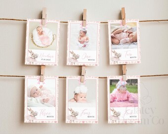 Op de afbeelding: Een set van zes rechthoekige fotokaarten die met houten knijpers aan een touwtje hangen. Elke kaart bevat een babyfoto, een roze strik en tekst die de leeftijdsmijlpalen van pasgeboren tot vijf maanden aangeeft, met een konijnillustratie.