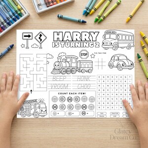 May include: A white activity sheet with black line art featuring a school bus, a train, a car, a fire truck, a maze, a word search, and the text HARRY IS TURNING 2. The sheet includes tracing practice for words like BEEP, HONK, VROOM, and CHOO.