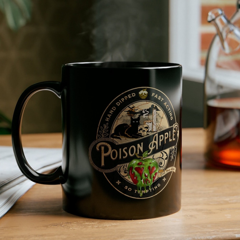 Vintage label for fake poison apple company, oval graphics say hand dipped fast acting so tempting poison apple, Snow white Poison Apple Halloween Coffee Mug, Vintage Looking Fairy Tale Poison Apple Mug, Evil Queen red apple green poison, black cat