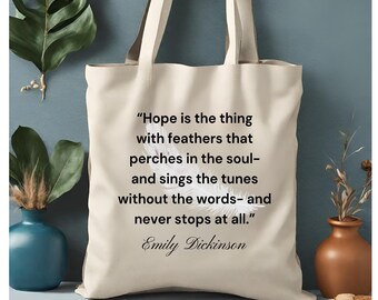 May include: A beige tote bag with a quote by Emily Dickinson printed on it. The quote reads: "Hope is the thing with feathers that perches in the soul- and sings the tunes without the words- and never stops at all."