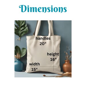 May include: A beige tote bag with black text that reads "handles 20", "height 16", "width 15". The bag is sitting on a blue surface with plants on either side.