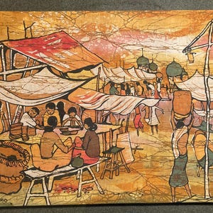 May include: An artistic painting depicting a bustling marketplace scene. The artwork features people at tables, vendors, and structures with red and white canopies. The color palette includes warm tones of orange, yellow, and brown, with accents of red and green.