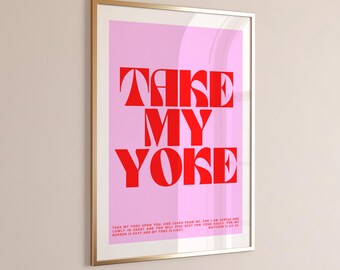 May include: Framed art print with a pink background and bold red text that reads "TAKE MY YOKE". The print includes a Bible verse at the bottom. The frame is gold.