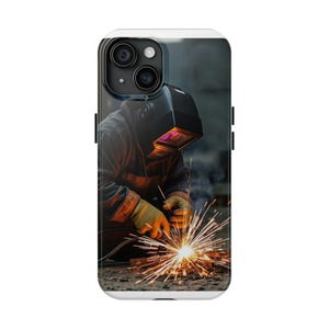 May include: Phone case featuring a welder at work. The image shows a person wearing a welding helmet and gloves, focused on the bright sparks from the welding process. The case has a white border and a black camera module.